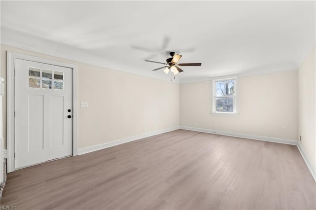 foyer entrance with light hardwood / wood-style floors and ceiling fan