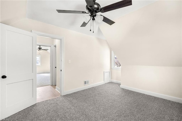 additional living space featuring light carpet and lofted ceiling