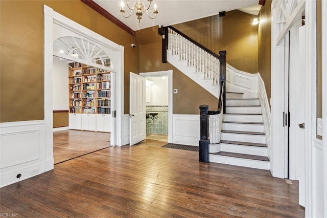 entrance foyer featuring an inviting chandelier and dark hardwood / wood-style floors