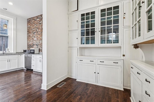 interior space with white cabinetry, dishwasher, sink, and dark hardwood / wood-style flooring