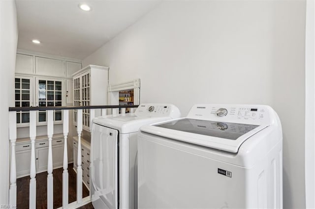 laundry area featuring dark wood-type flooring and washing machine and dryer