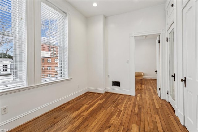 unfurnished bedroom featuring light hardwood / wood-style floors and a closet