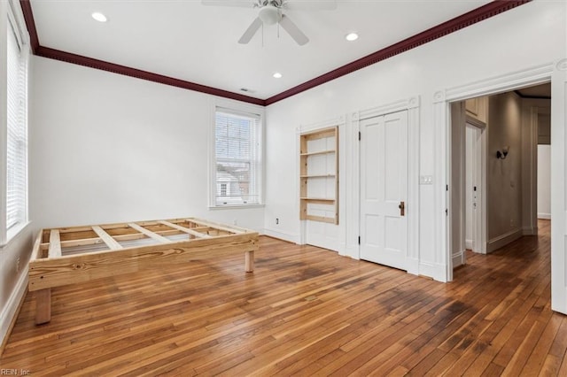 interior space with crown molding, ceiling fan, and hardwood / wood-style flooring