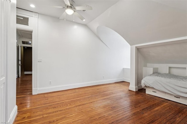 unfurnished bedroom with hardwood / wood-style flooring, vaulted ceiling, and ceiling fan