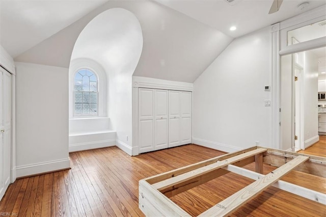 bonus room with hardwood / wood-style flooring, vaulted ceiling, and ceiling fan