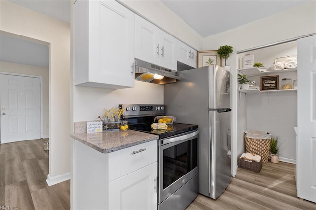 kitchen with stainless steel range with electric stovetop, light stone countertops, white cabinets, and light wood-type flooring