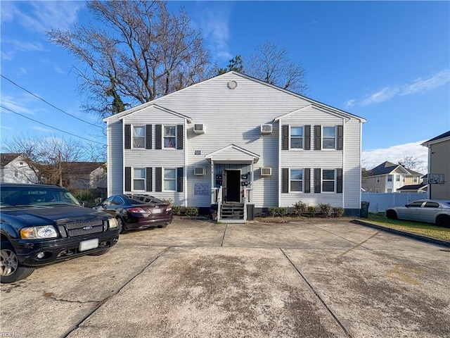 view of front of property featuring a wall mounted AC