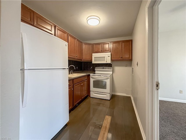 kitchen with tasteful backsplash, dark hardwood / wood-style flooring, sink, and white appliances