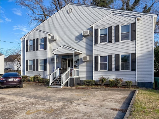 front of property featuring a wall mounted air conditioner