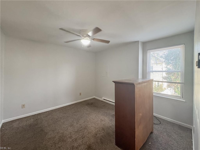 carpeted empty room featuring baseboard heating and ceiling fan