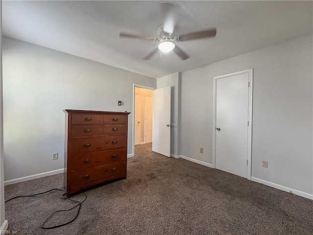 unfurnished bedroom with ceiling fan and dark carpet