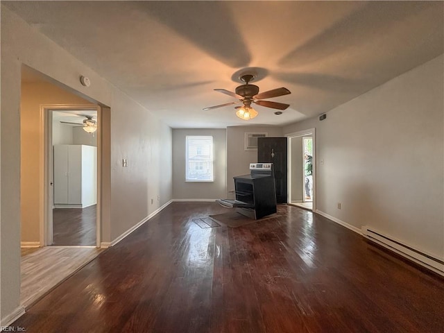 unfurnished living room with ceiling fan, a baseboard heating unit, and dark hardwood / wood-style flooring