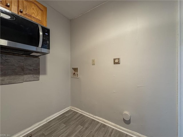 washroom with dark hardwood / wood-style flooring, hookup for a washing machine, and hookup for an electric dryer