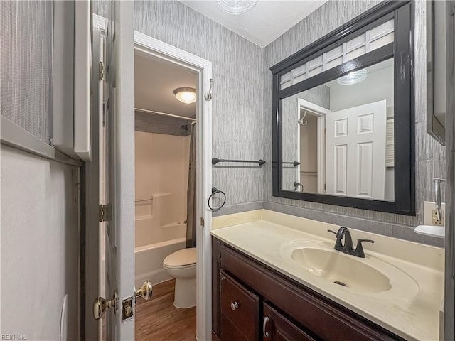 full bathroom with vanity, toilet, tub / shower combination, and hardwood / wood-style floors