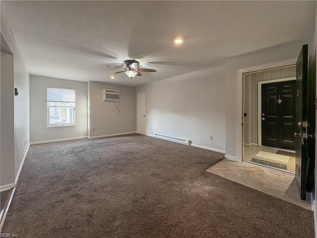 spare room featuring a baseboard heating unit, a wall mounted air conditioner, ceiling fan, and carpet flooring