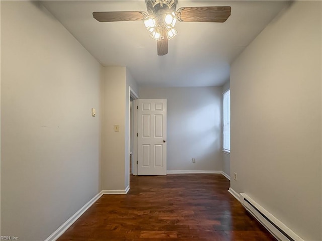 corridor with dark hardwood / wood-style floors and a baseboard heating unit