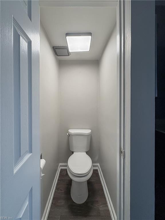 bathroom featuring hardwood / wood-style flooring and toilet