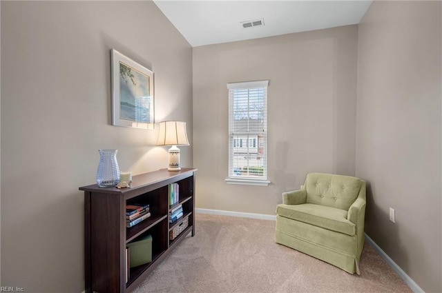 living area with light colored carpet