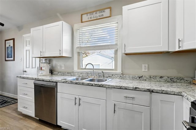 kitchen featuring white cabinetry, dishwasher, sink, light stone counters, and light hardwood / wood-style flooring