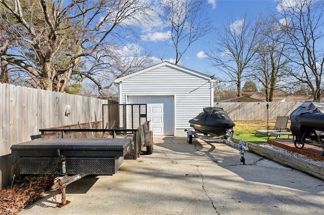 view of patio / terrace with a garage and an outdoor structure