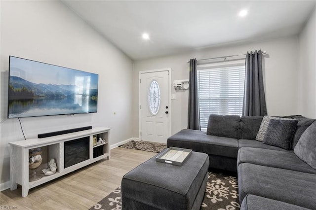 living room with vaulted ceiling and light hardwood / wood-style floors