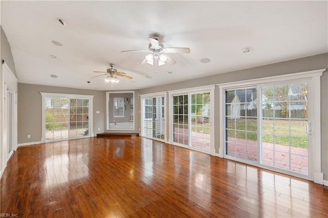 unfurnished living room featuring wood-type flooring and ceiling fan