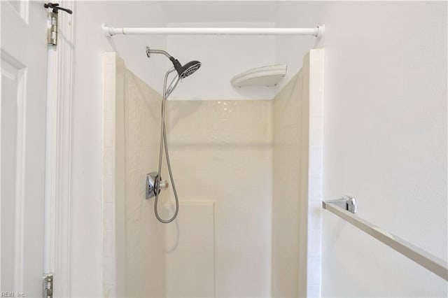 bathroom with tiled shower