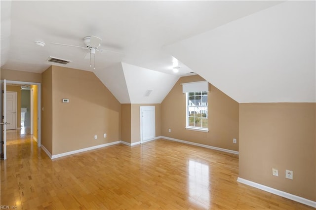 additional living space with vaulted ceiling, ceiling fan, and light hardwood / wood-style floors