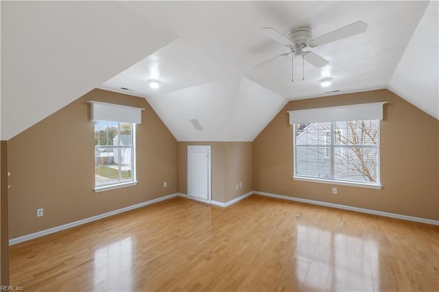 additional living space featuring vaulted ceiling, ceiling fan, and light wood-type flooring