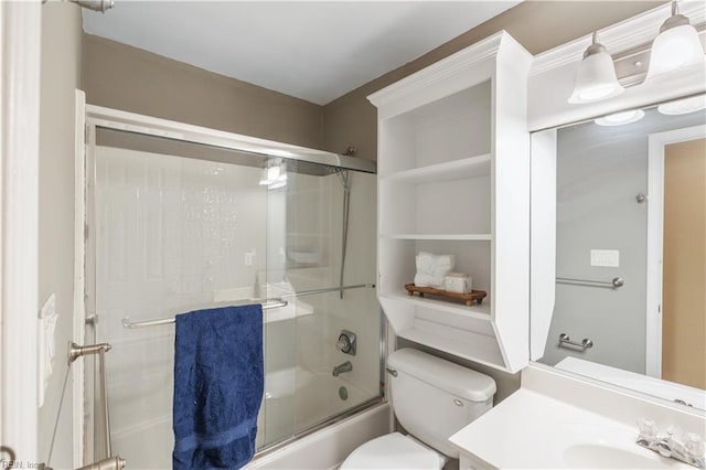 full bathroom with vanity, toilet, and combined bath / shower with glass door