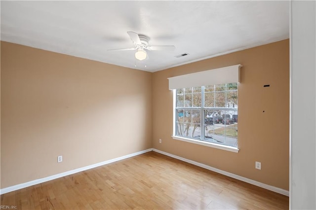 empty room featuring ceiling fan and light hardwood / wood-style floors