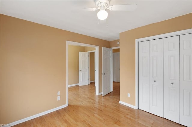 unfurnished bedroom with ceiling fan, wood-type flooring, and a closet