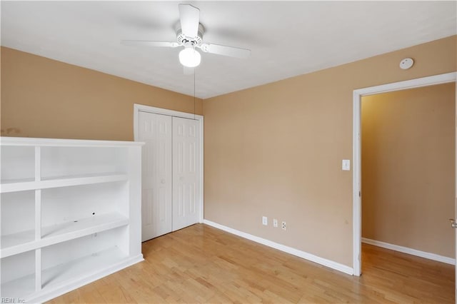 unfurnished bedroom with hardwood / wood-style floors, ceiling fan, and a closet