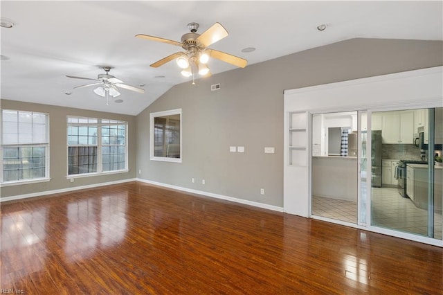 unfurnished living room with hardwood / wood-style flooring, ceiling fan, and lofted ceiling