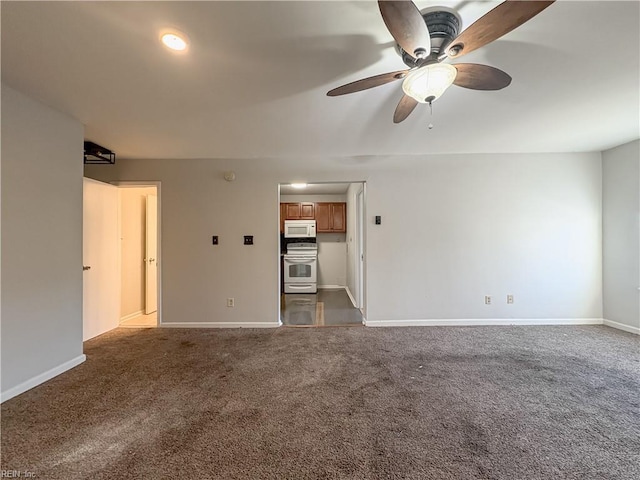 empty room featuring ceiling fan and dark carpet