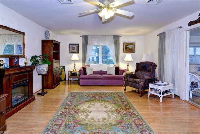 living room with ceiling fan and light wood-type flooring