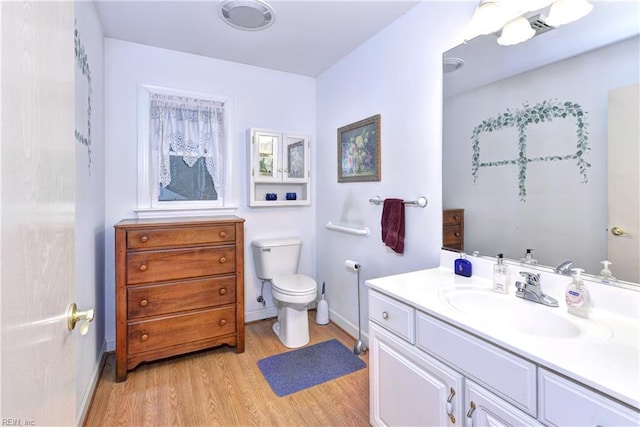 bathroom with vanity, hardwood / wood-style floors, and toilet