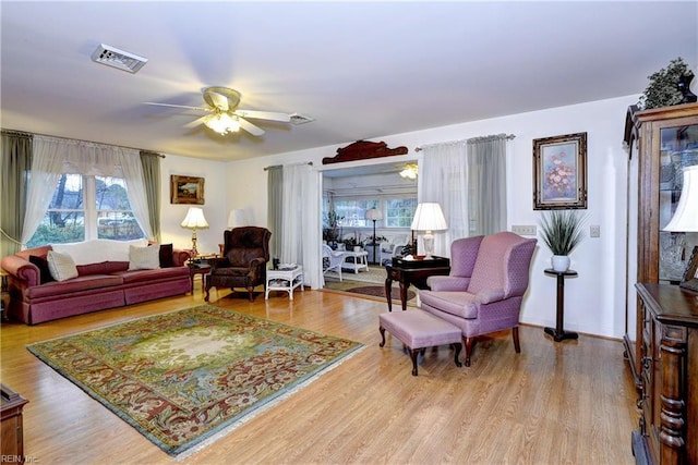 living room with ceiling fan and light wood-type flooring