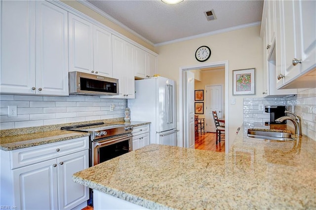 kitchen with sink, white cabinets, and appliances with stainless steel finishes