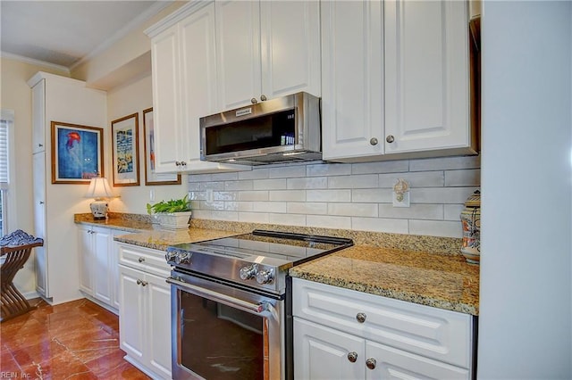 kitchen with light stone countertops, appliances with stainless steel finishes, and white cabinets