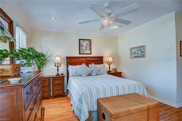 bedroom featuring crown molding, light hardwood / wood-style floors, and a textured ceiling