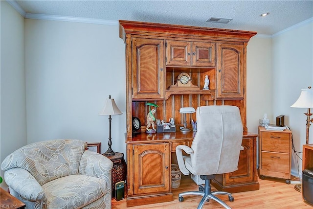 home office featuring crown molding, a textured ceiling, and light hardwood / wood-style flooring