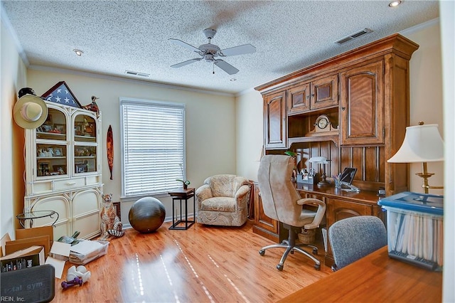 office area featuring ceiling fan, ornamental molding, light hardwood / wood-style floors, and a textured ceiling