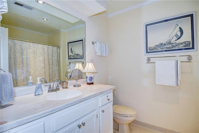 bathroom with crown molding, vanity, tile patterned floors, and toilet