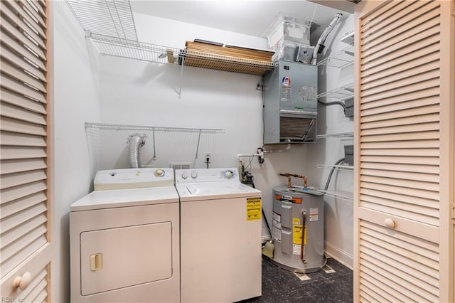 laundry room featuring water heater and separate washer and dryer