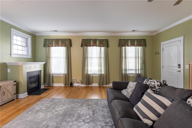 living room featuring hardwood / wood-style flooring and ornamental molding