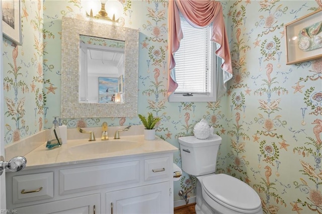 bathroom featuring vanity and toilet