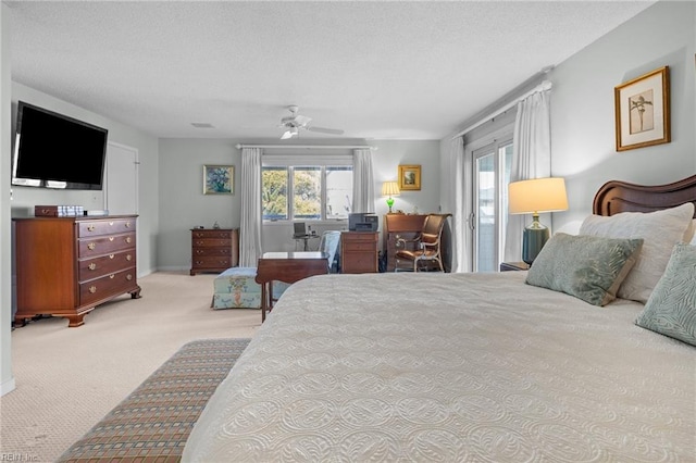 carpeted bedroom with ceiling fan, multiple windows, and a textured ceiling