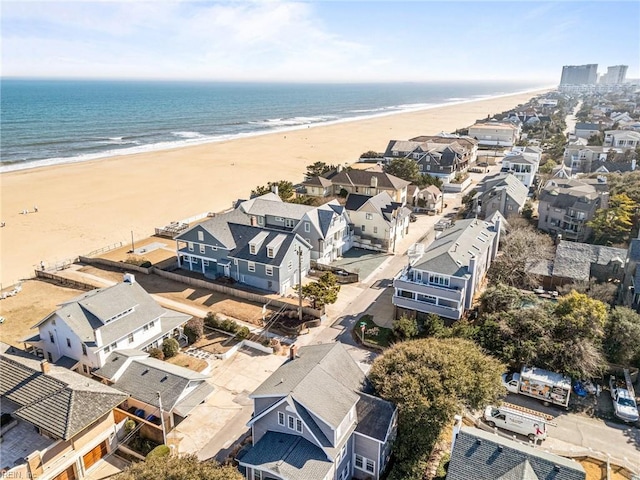 birds eye view of property featuring a view of the beach and a water view