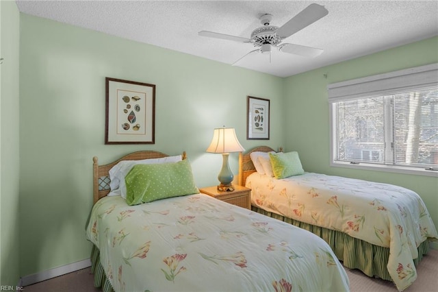 bedroom featuring ceiling fan and a textured ceiling